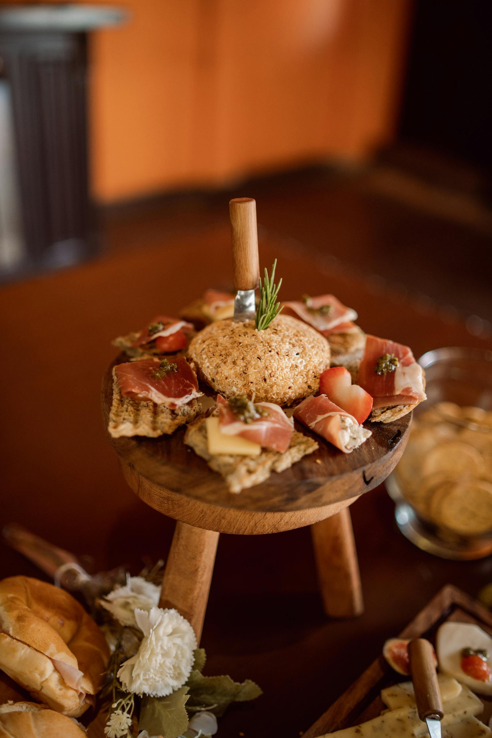 A rustic display of cheese and cold cuts on a wooden board, perfect for events.